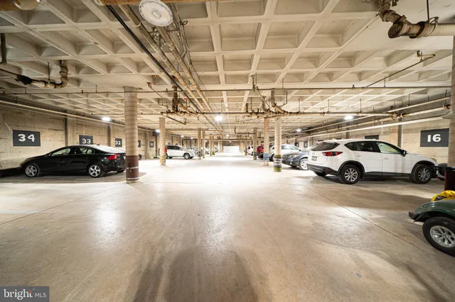 a living room with furniture and a view of kitchen
