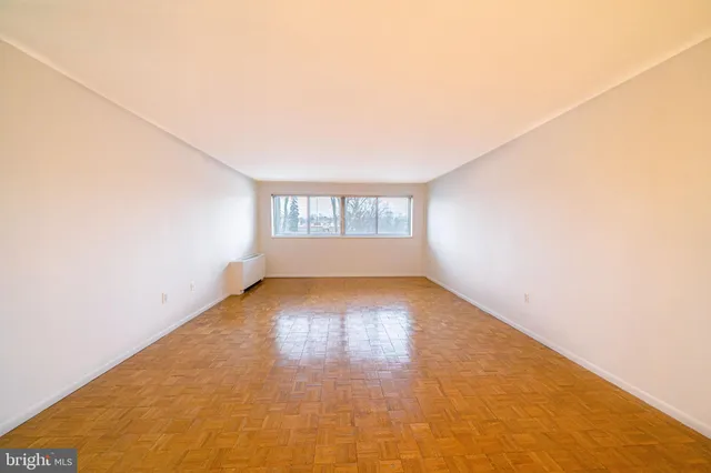 a kitchen with a refrigerator a stove and cabinets