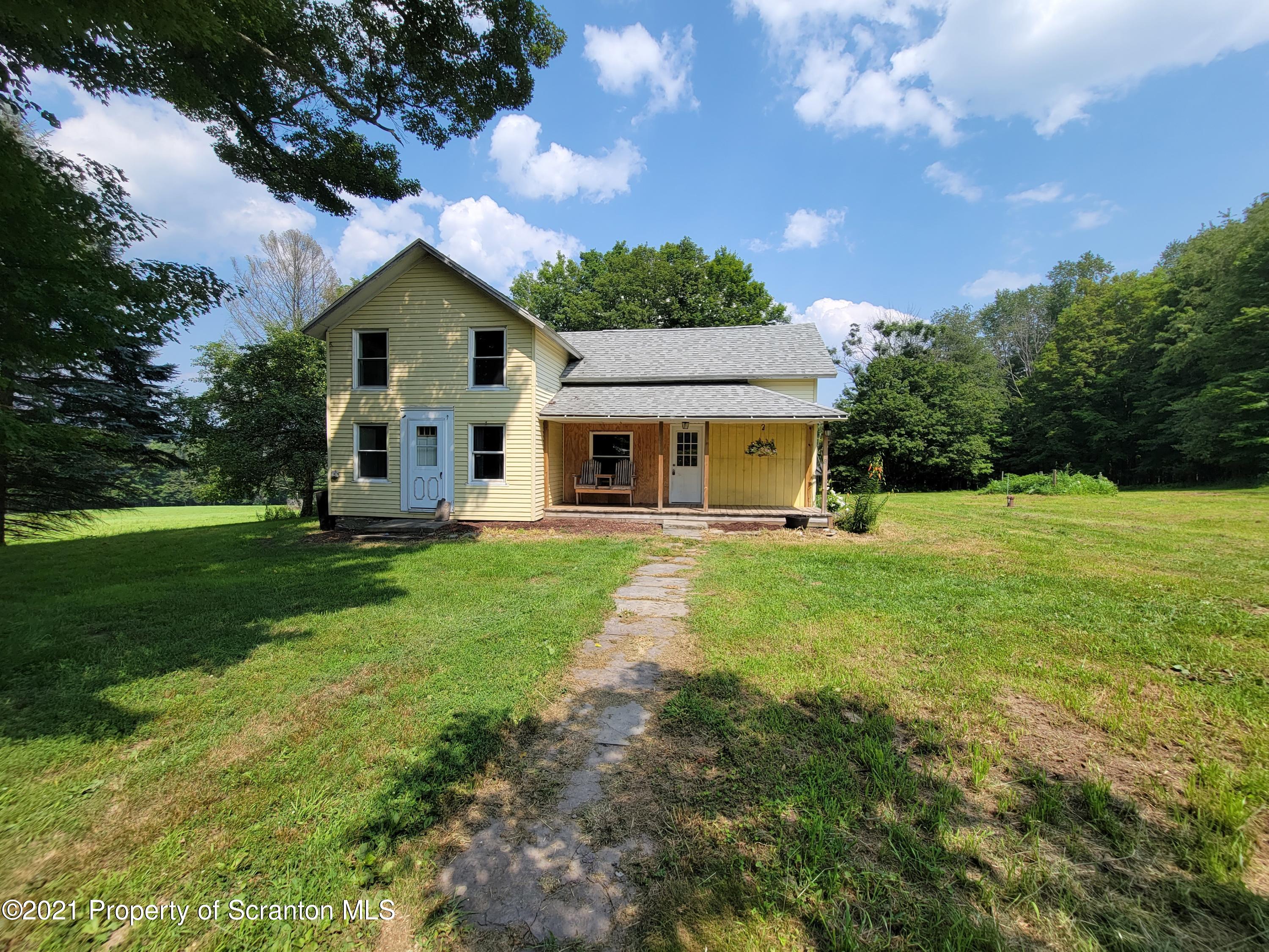 686 Wilcox Road Meshoppen, PA 18630 - Photo 1 of 30 a front view of a house with yard and green space
