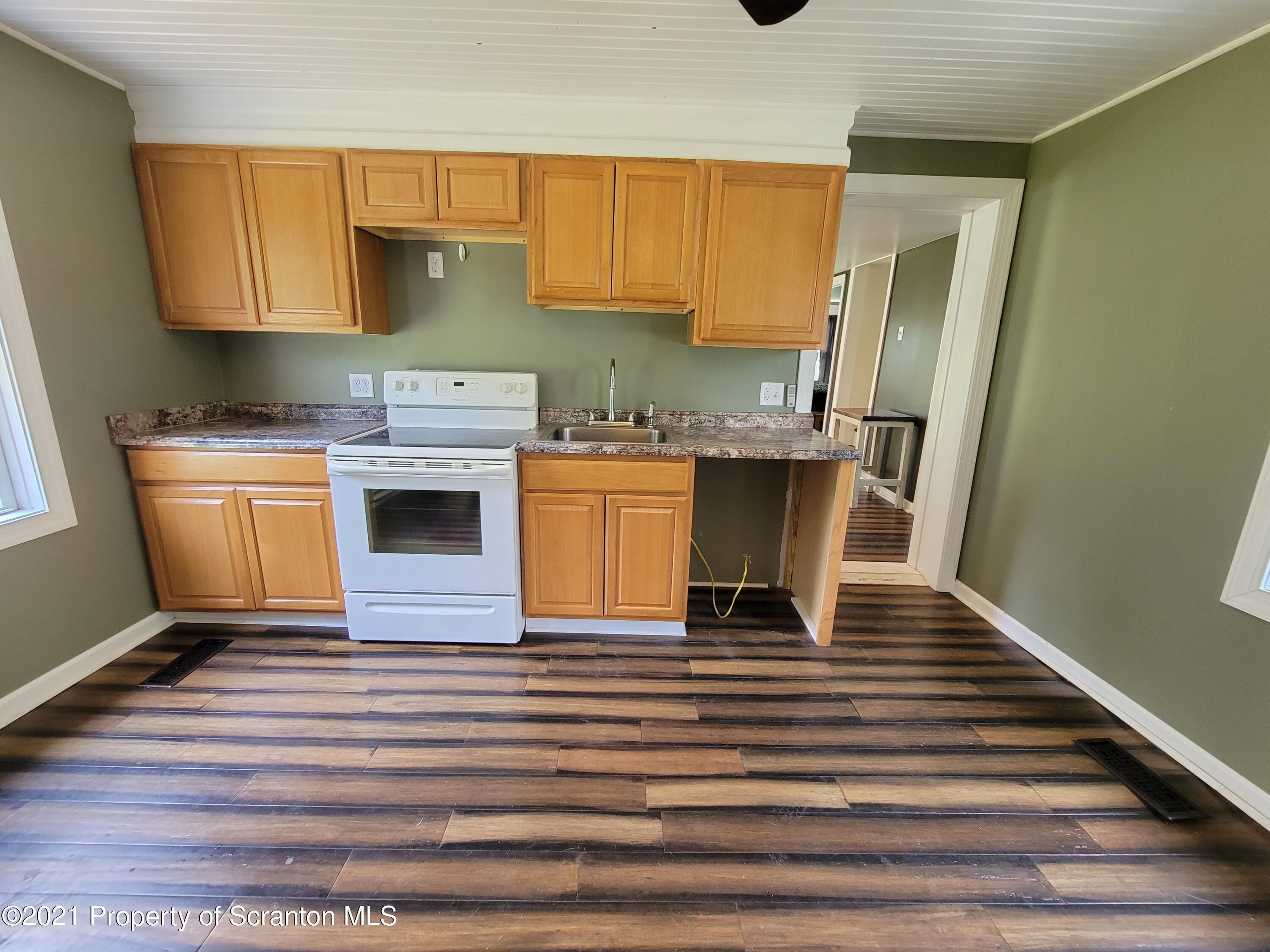 686 Wilcox Road Meshoppen, PA 18630 - Photo 11 of 30 a kitchen with stainless steel appliances granite countertop a sink stove and refrigerator