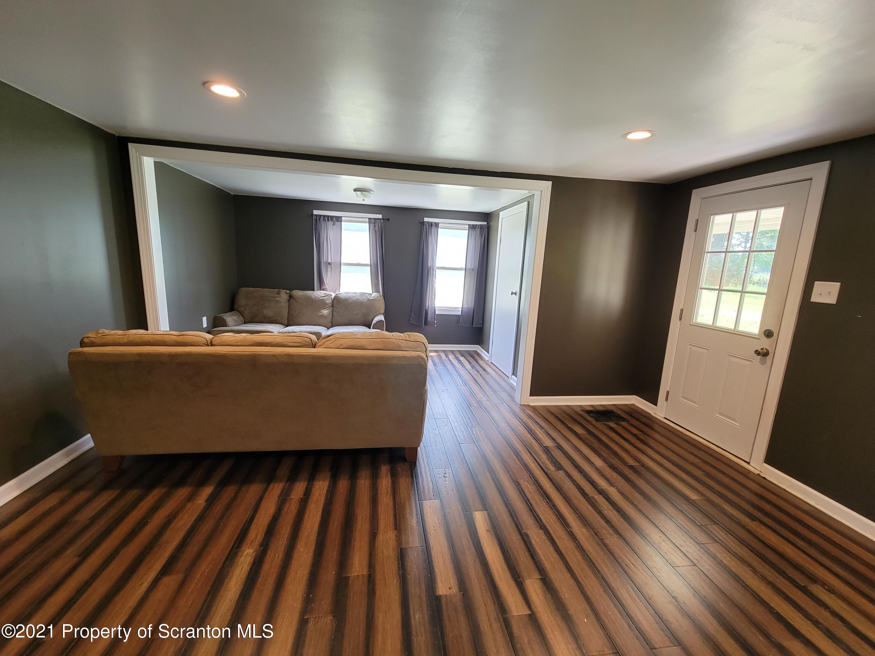 686 Wilcox Road Meshoppen, PA 18630 - Photo 15 of 30 a living room with furniture and a fireplace
