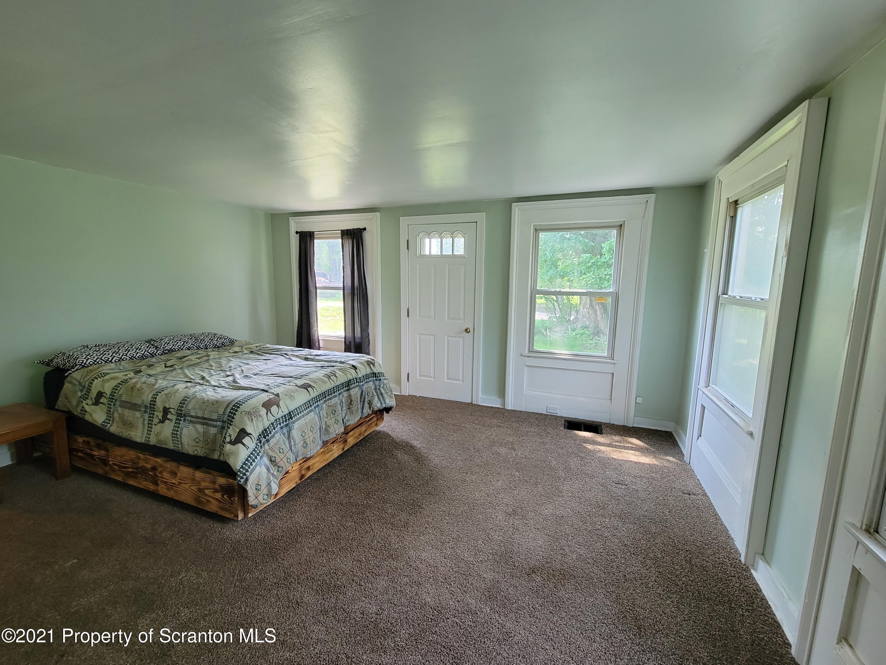 686 Wilcox Road Meshoppen, PA 18630 - Photo 18 of 30 a spacious bedroom with a bed and window