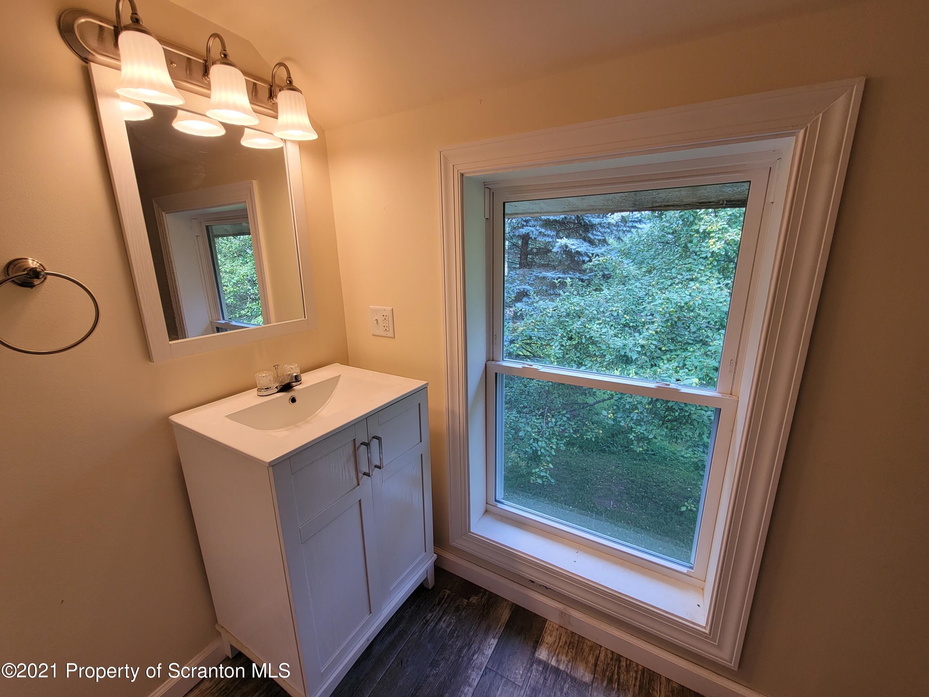 686 Wilcox Road Meshoppen, PA 18630 - Photo 23 of 30 a bathroom with a sink vanity mirror and tub