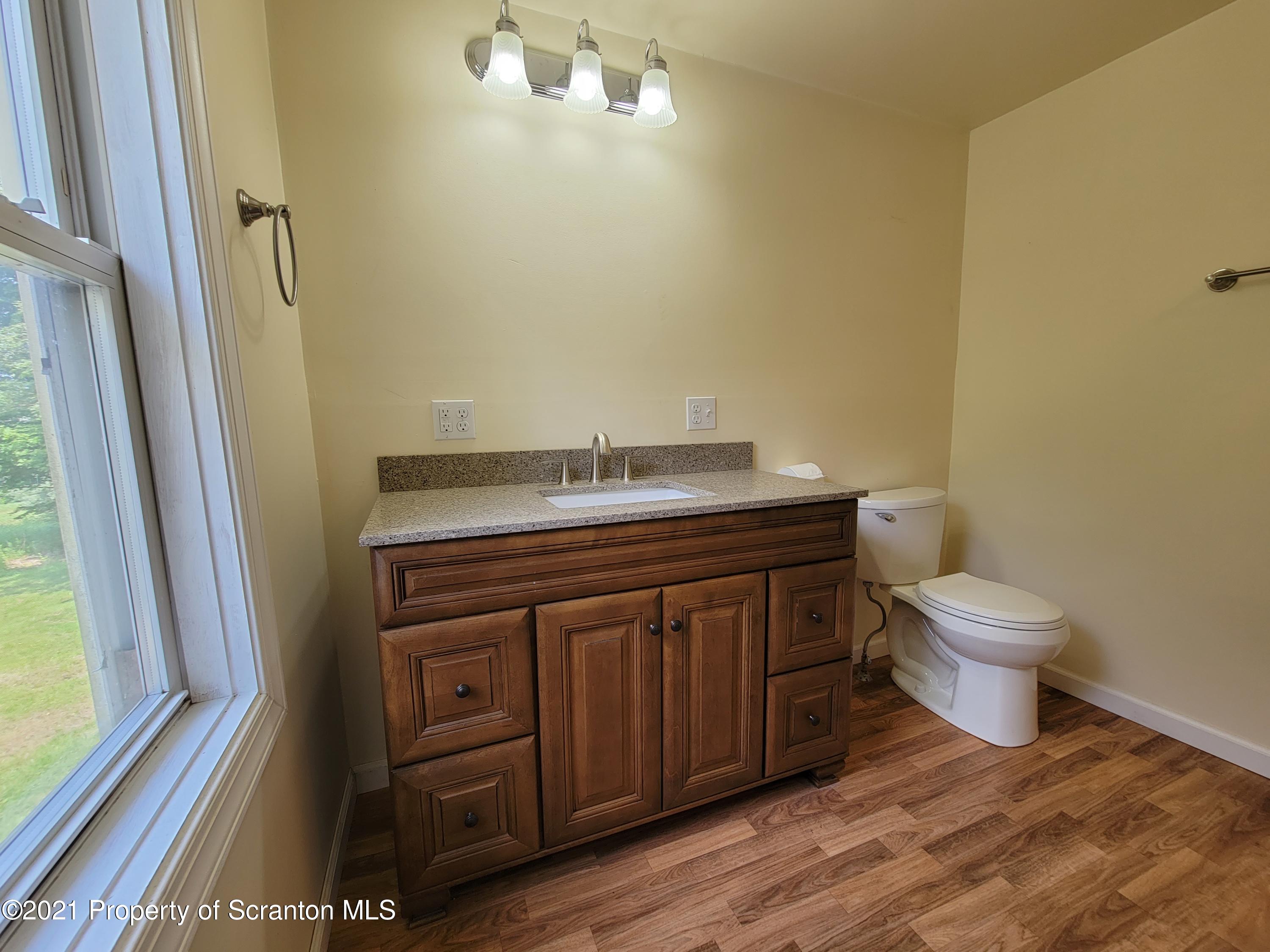 686 Wilcox Road Meshoppen, PA 18630 - Photo 25 of 30 a bathroom with a granite countertop toilet and a sink