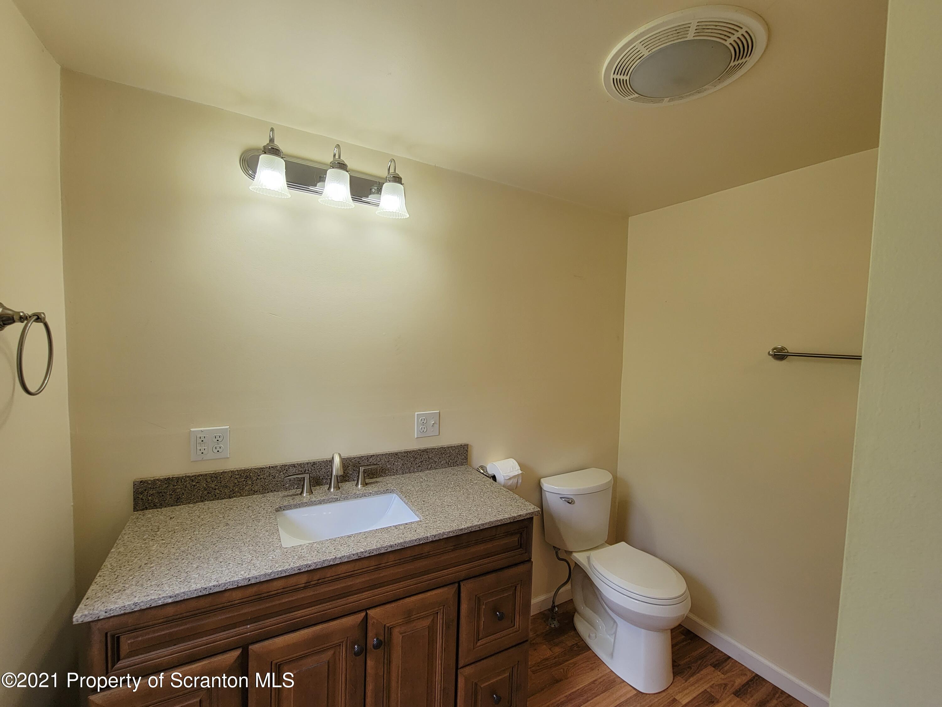 686 Wilcox Road Meshoppen, PA 18630 - Photo 26 of 30 a bathroom with a granite countertop sink and a toilet