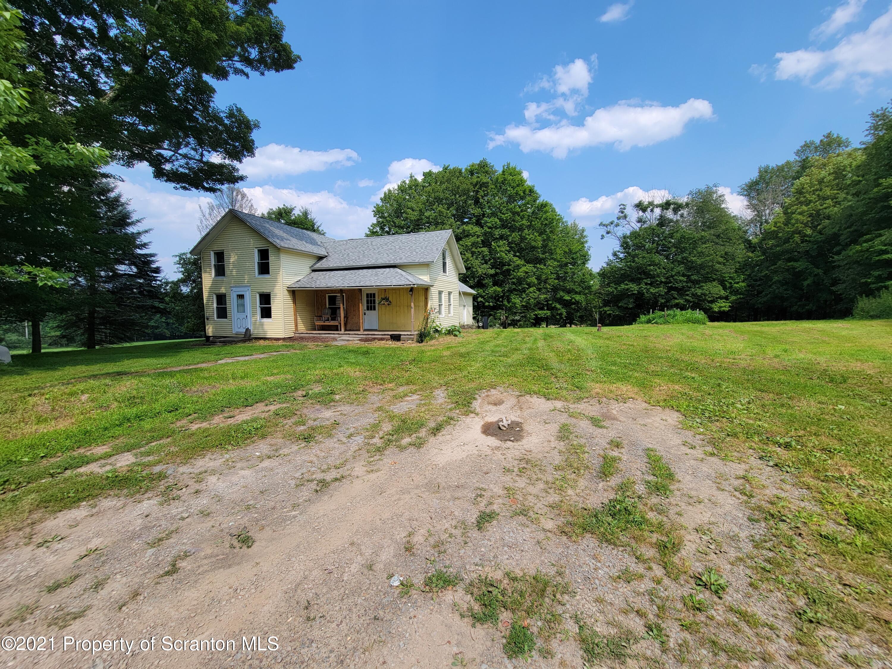 686 Wilcox Road Meshoppen, PA 18630 - Photo 5 of 30 a front view of a house with a yard