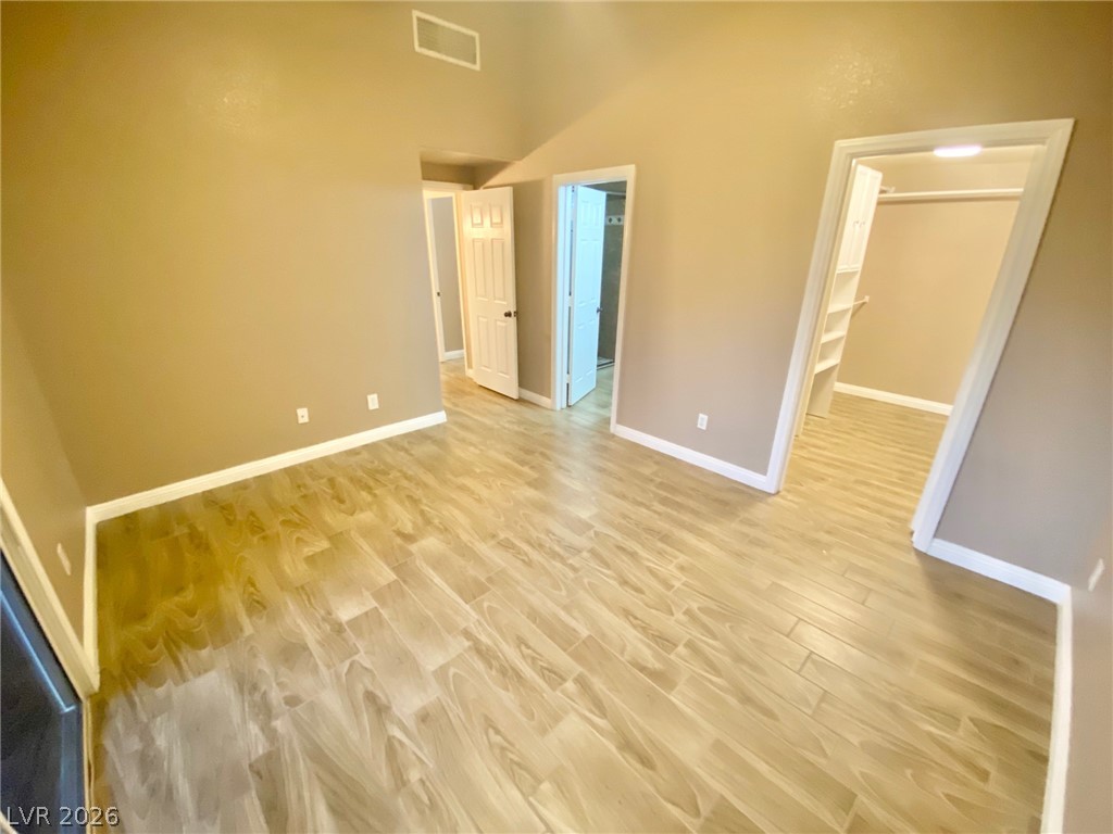 2000 Turquoise Ridge Street, Unit 204 Las Vegas, NV 89117 - Photo 2 of 29 Natural wood-look flooring enhances this versatile living space, featuring high vaulted ceilings.