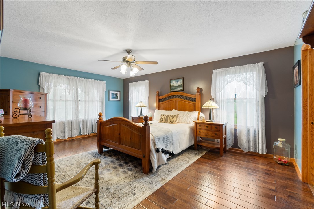 5212 Gray Road Ravenna, OH 44266 - Photo 13 of 37 Primary Bedroom featuring hardwood / wood-style floors, ceiling fan, and a textured ceiling