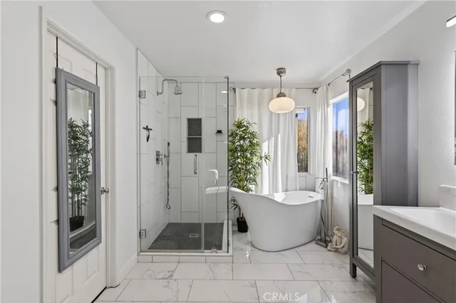 a living room with a couch and a potted plant