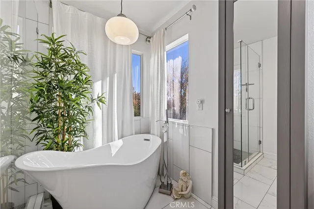 a bath tub sitting in a bathroom next to a window