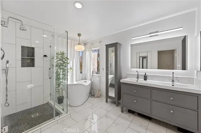 a bathroom with a double vanity sink mirror and shower