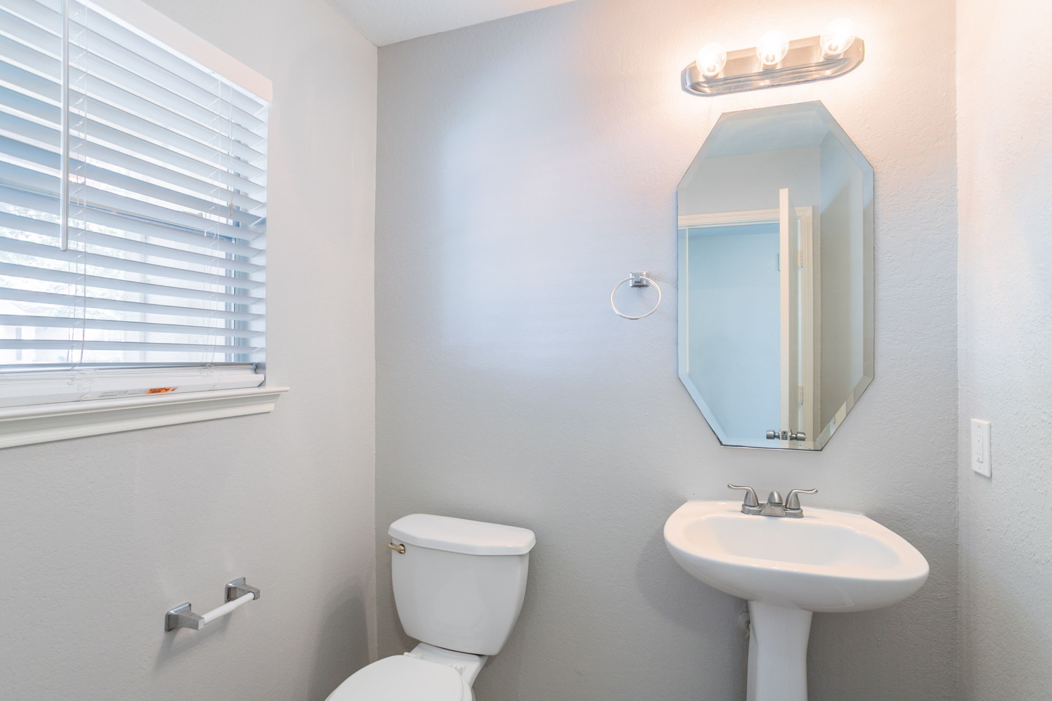 12026 Madison Oak Street Houston, TX 77038 - Photo 17 of 39 a bathroom with a toilet sink and mirror