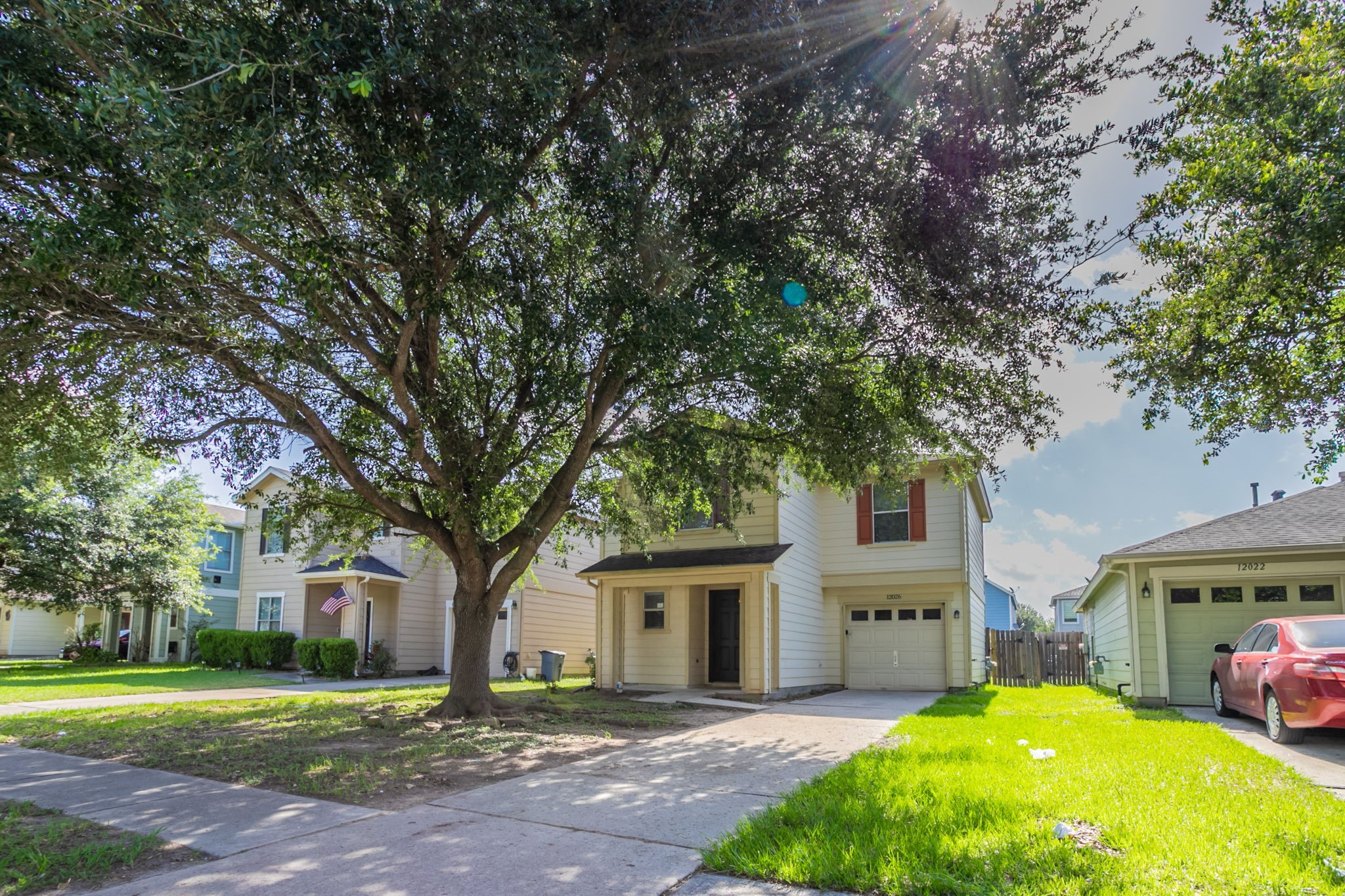 12026 Madison Oak Street Houston, TX 77038 - Photo 2 of 39 a front view of a house with a garden and trees