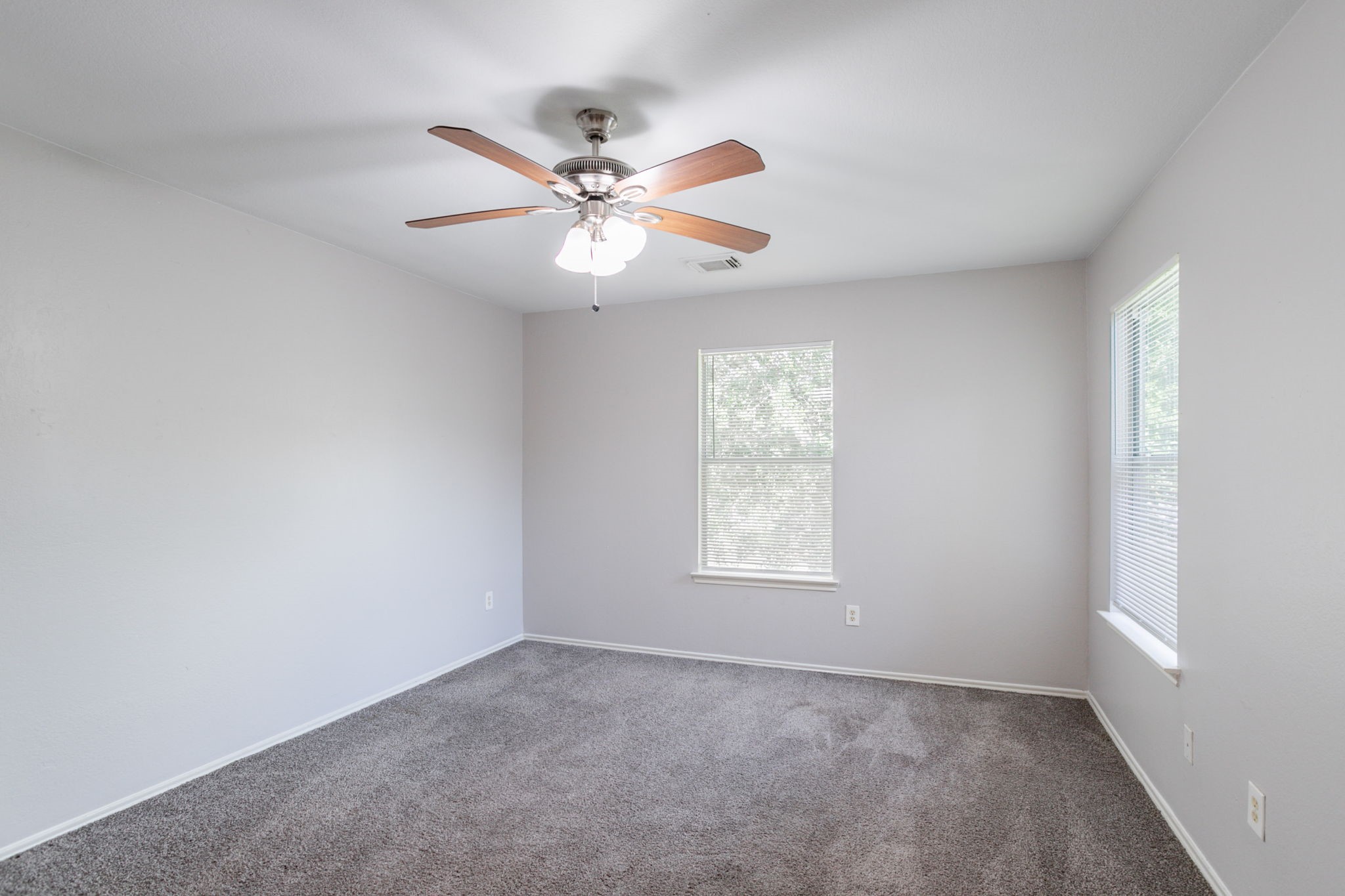 12026 Madison Oak Street Houston, TX 77038 - Photo 23 of 39 an empty room with windows and fan