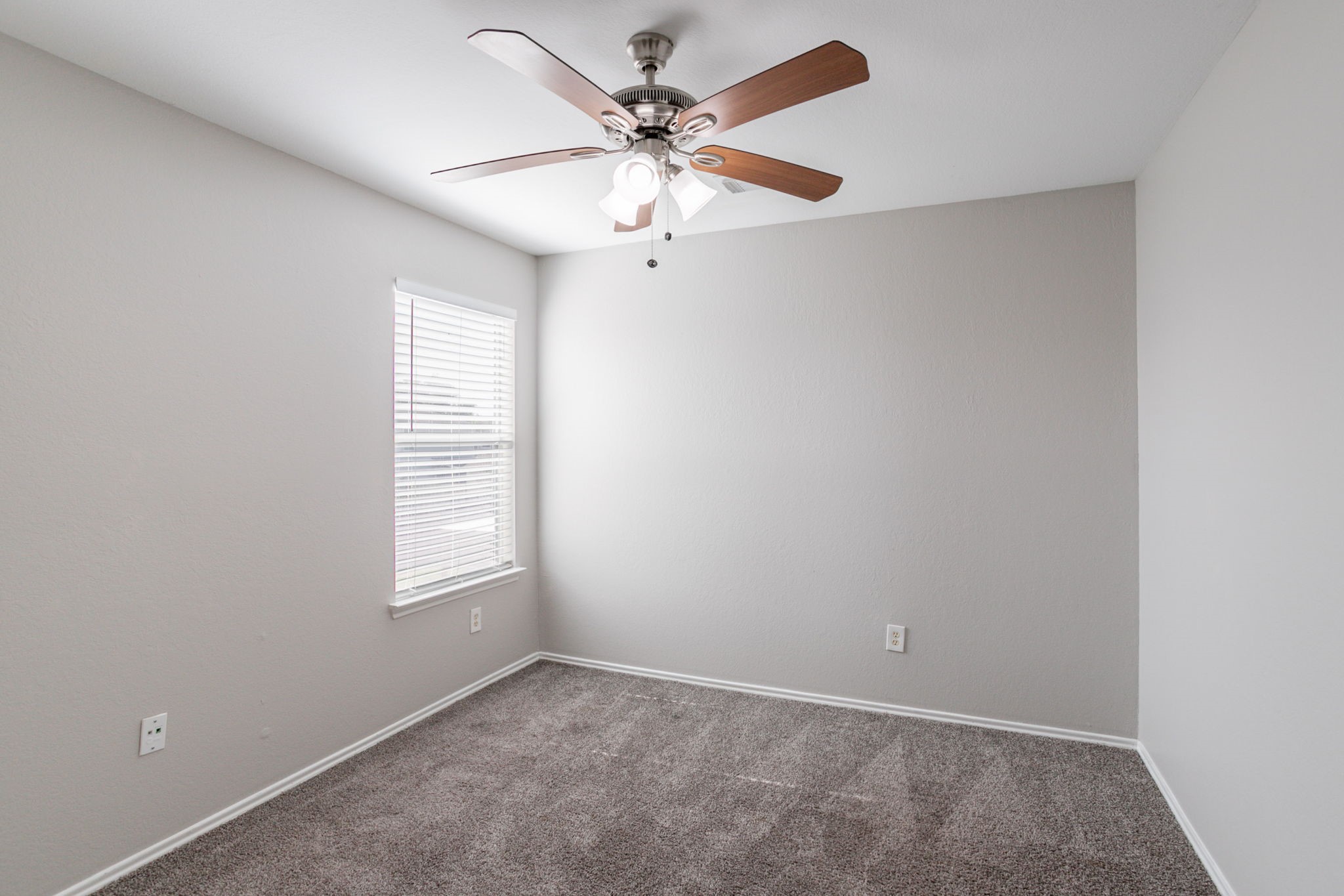 12026 Madison Oak Street Houston, TX 77038 - Photo 28 of 39 an empty room with windows and fan