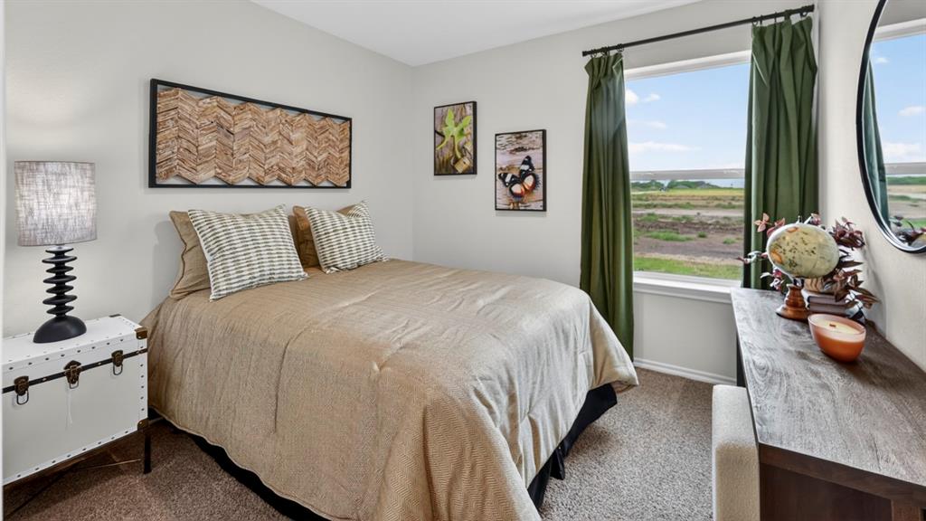 3514 Spring Time Street Terrell, TX 75126 - Photo 23 of 26 Bedroom featuring a window with a natural landscape, neutral wall tones, and carpeted flooring