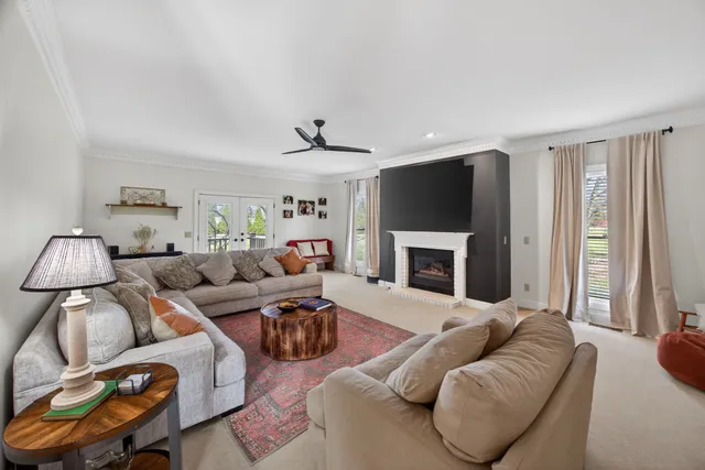 a living room with furniture a fireplace and a flat screen tv
