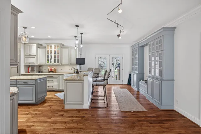 a kitchen with a stove and a white wooden cabinets
