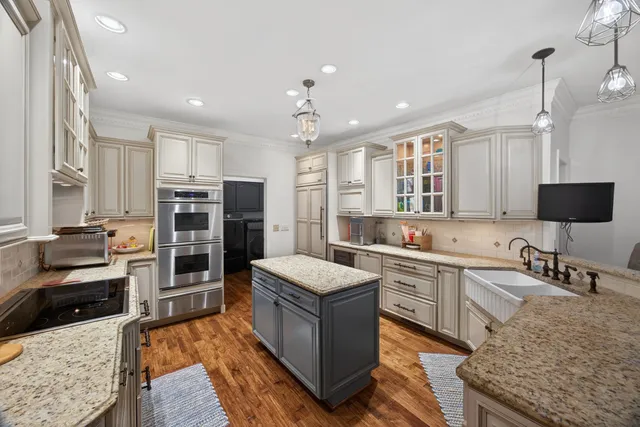 a kitchen with a stove sink and cabinets