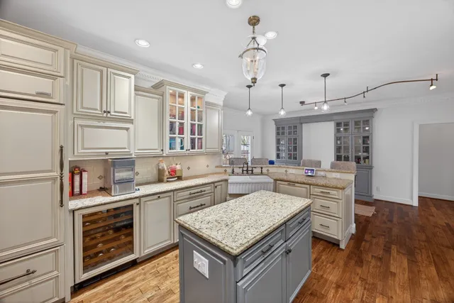 a kitchen with granite countertop stainless steel appliances a sink stove and refrigerator