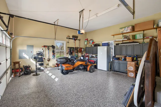 a bedroom with a bed and a flat tv screen on dresser
