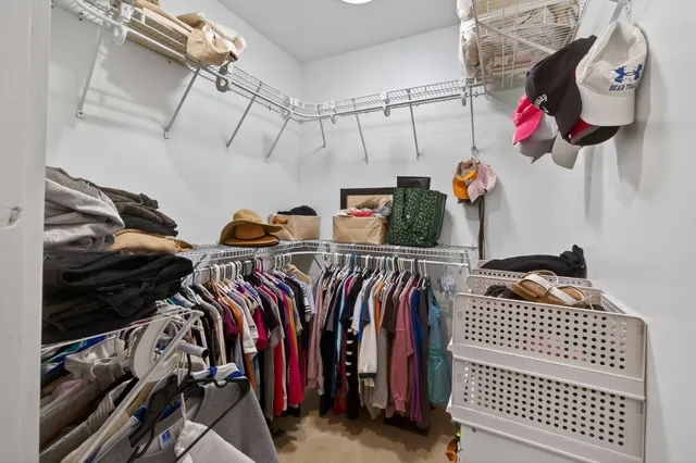 a bed room with a bed and a chair