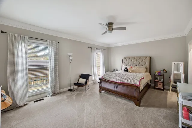 a view of a hallway to a livingroom with furniture and stairs