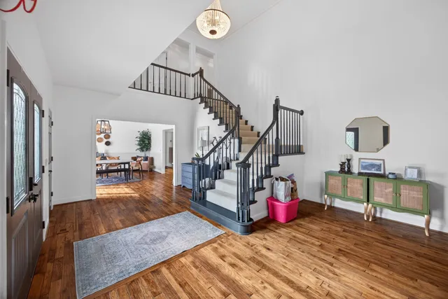 a view of entryway livingroom and hall with wooden floor