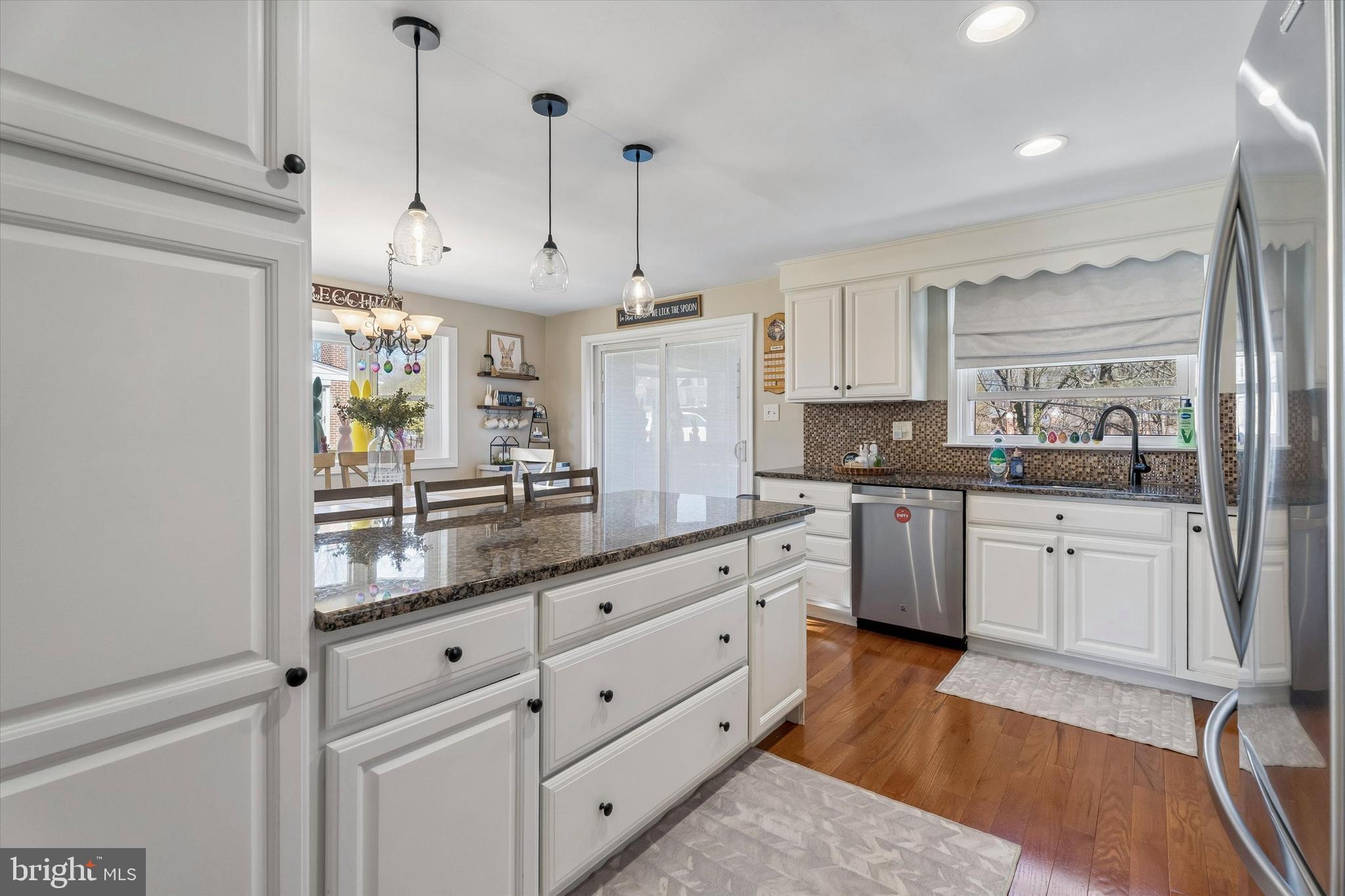 249 Gleaves Road Springfield, PA 19064 - Photo 13 of 34 a large kitchen with kitchen island white cabinets and wooden floor