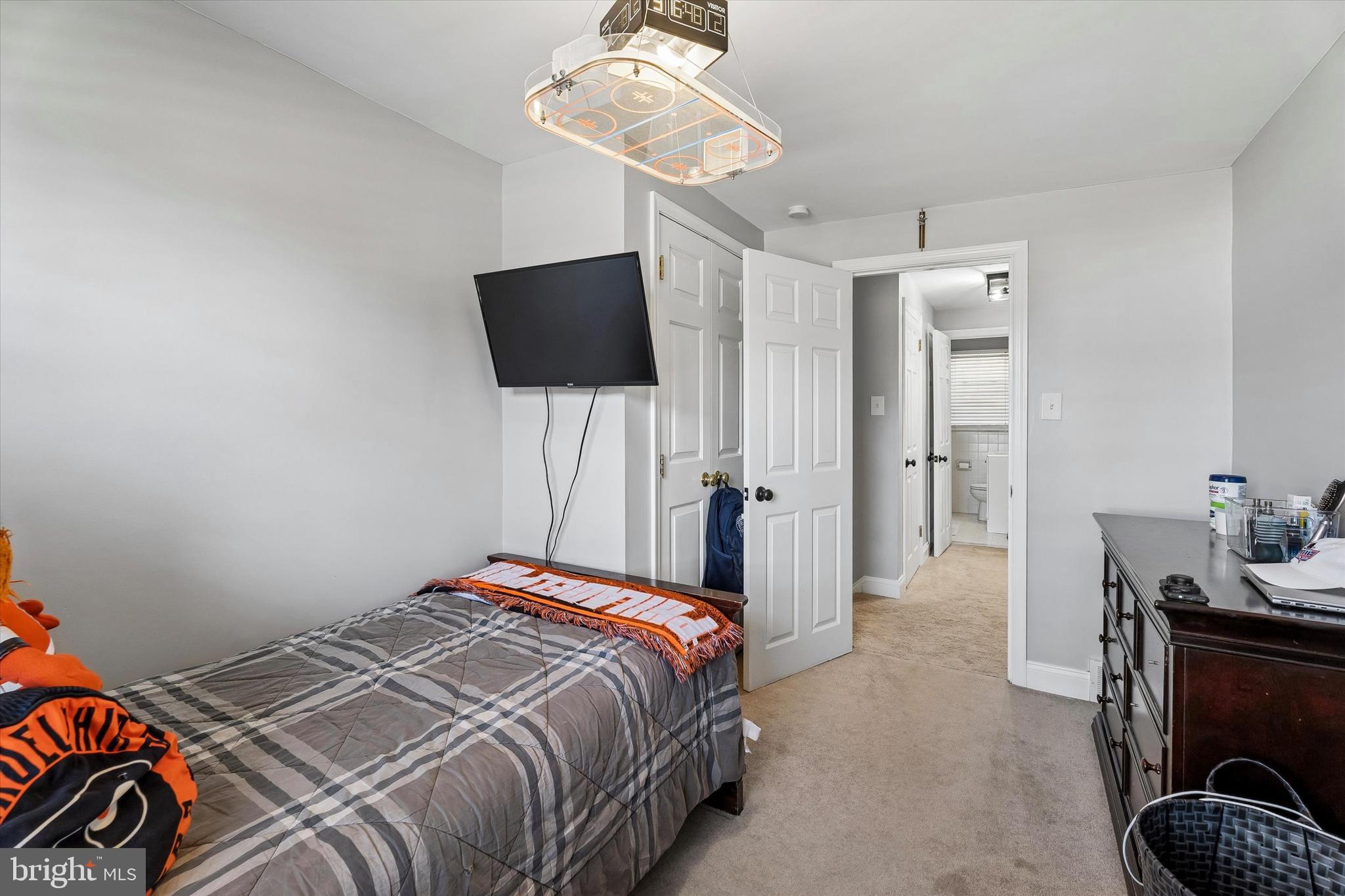 249 Gleaves Road Springfield, PA 19064 - Photo 28 of 34 a bedroom with a bed and a chandelier