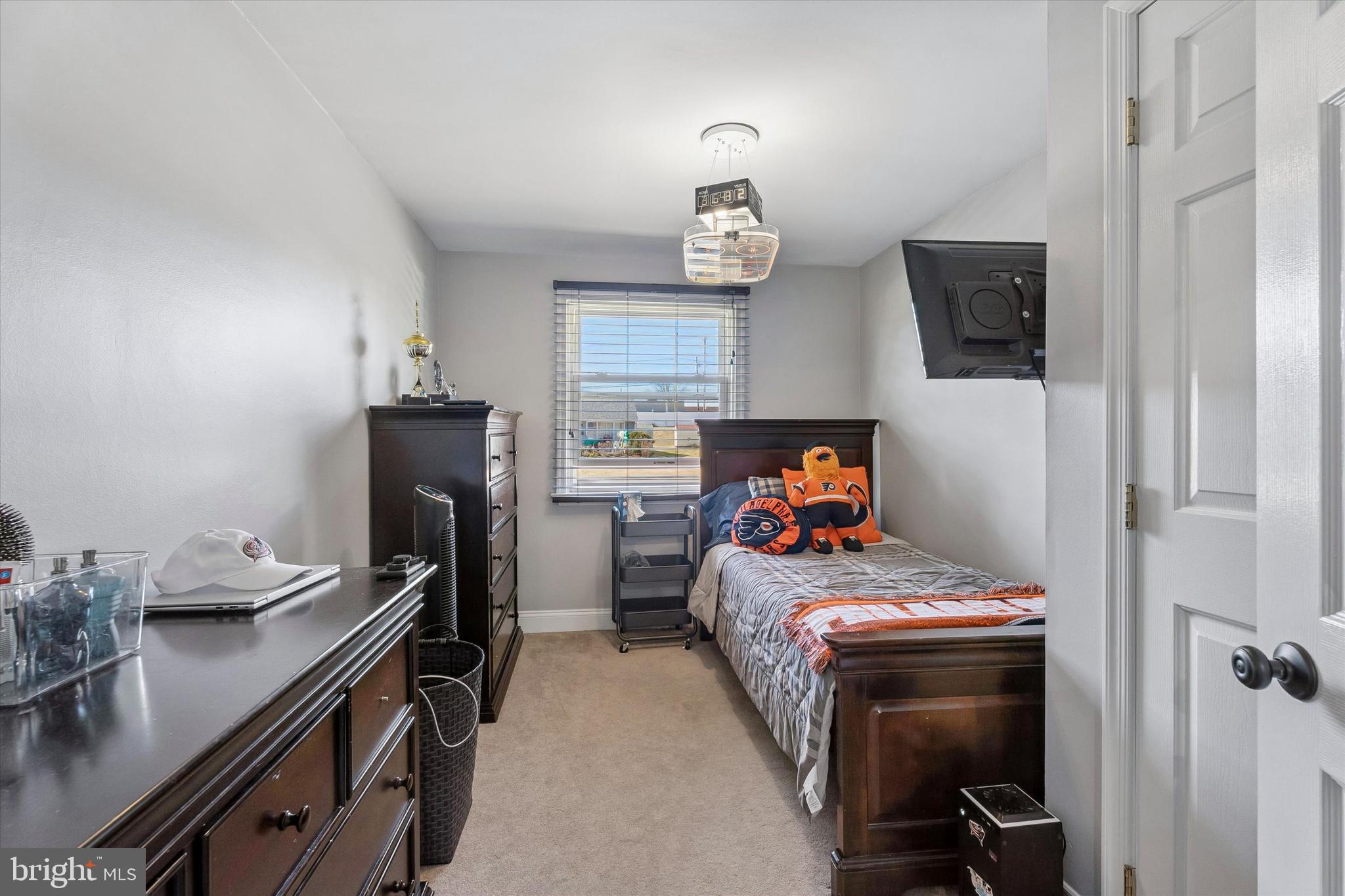 249 Gleaves Road Springfield, PA 19064 - Photo 29 of 34 a bedroom with a bed and a chandelier