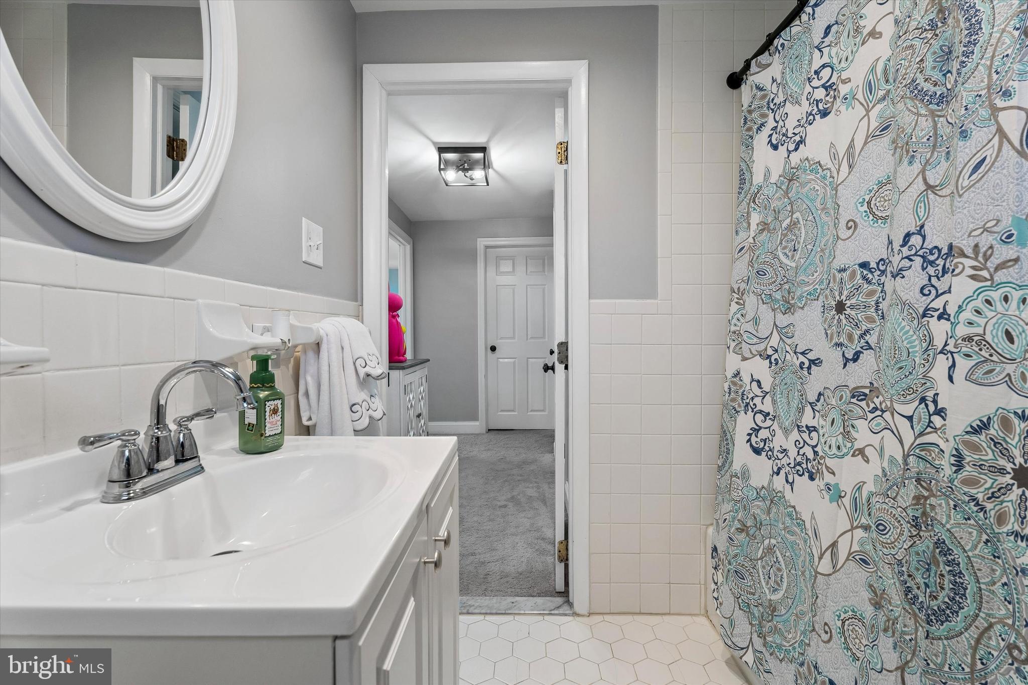 249 Gleaves Road Springfield, PA 19064 - Photo 30 of 34 a bathroom with a sink a toilet and a mirror