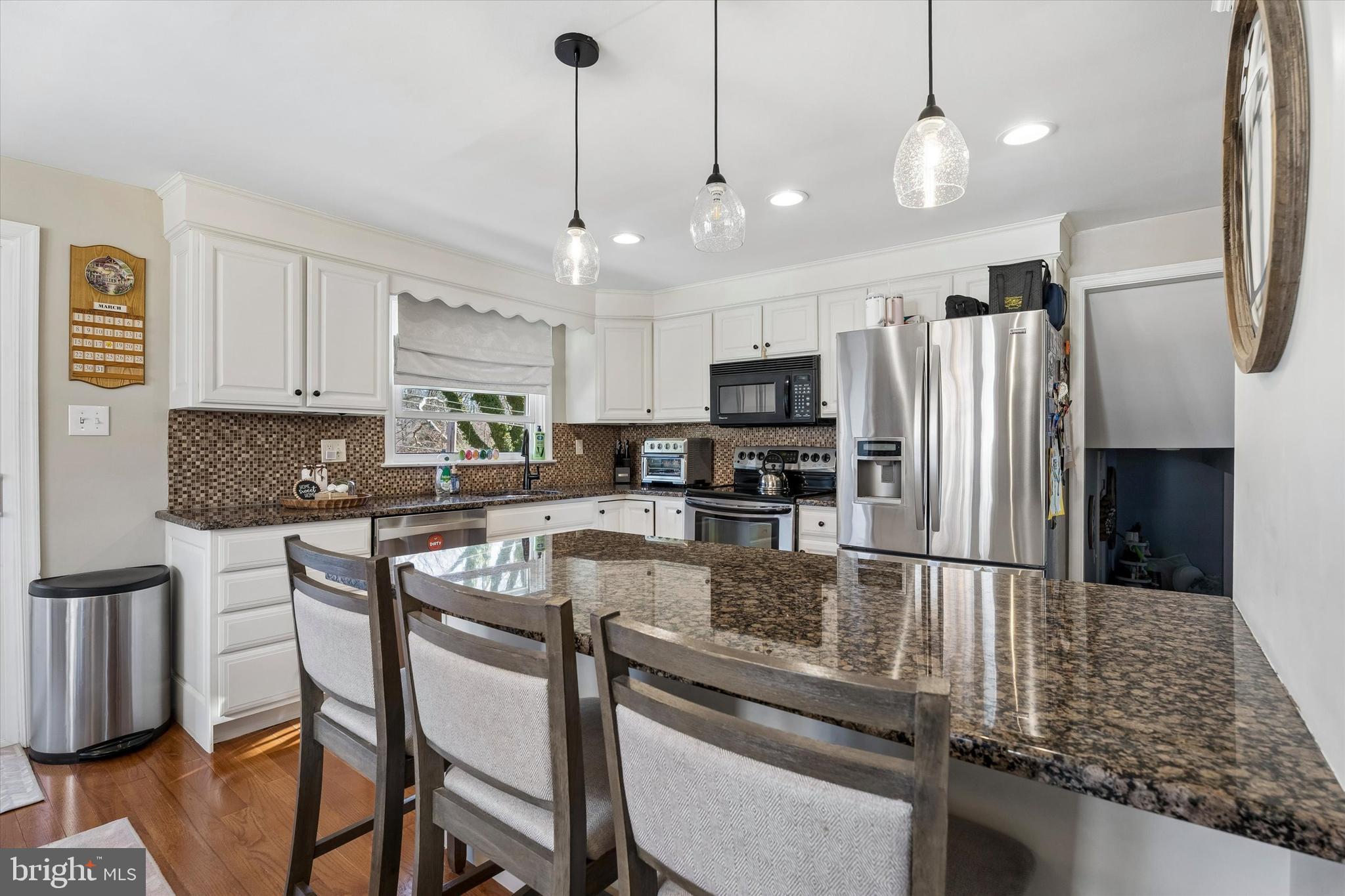 249 Gleaves Road Springfield, PA 19064 - Photo 10 of 34 a kitchen with stainless steel appliances granite countertop a sink refrigerator and microwave