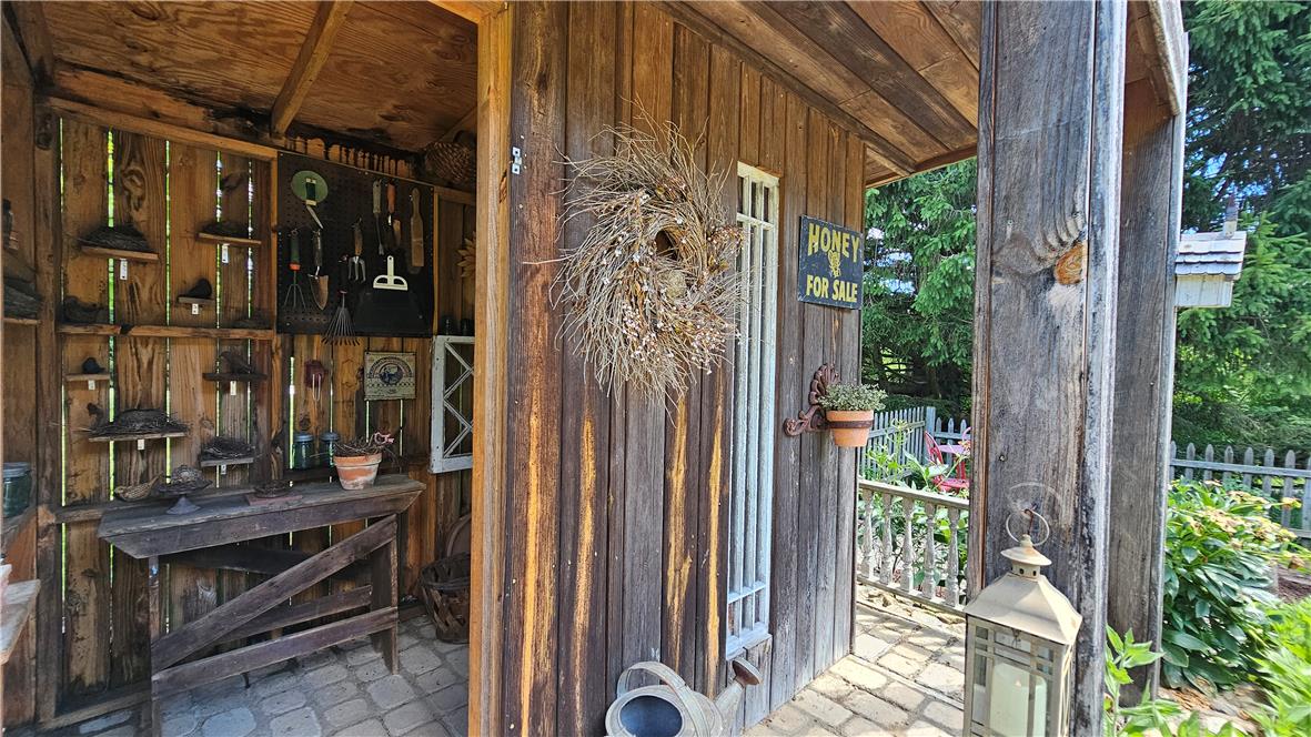 585 Buttermilk Road Hellertown, PA 18055 - Photo 54 of 82 A charming wooden shed offers practical outdoor storage and a quaint, rustic aesthetic.