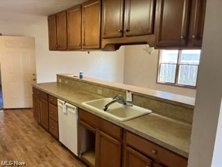 18601 Libby Road Maple Heights, OH 44137 - Photo 8 of 20 Kitchen with brown cabinets, white dishwasher, light countertops, and light hardwood flooring