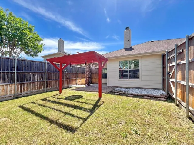 a view of a backyard with sitting area