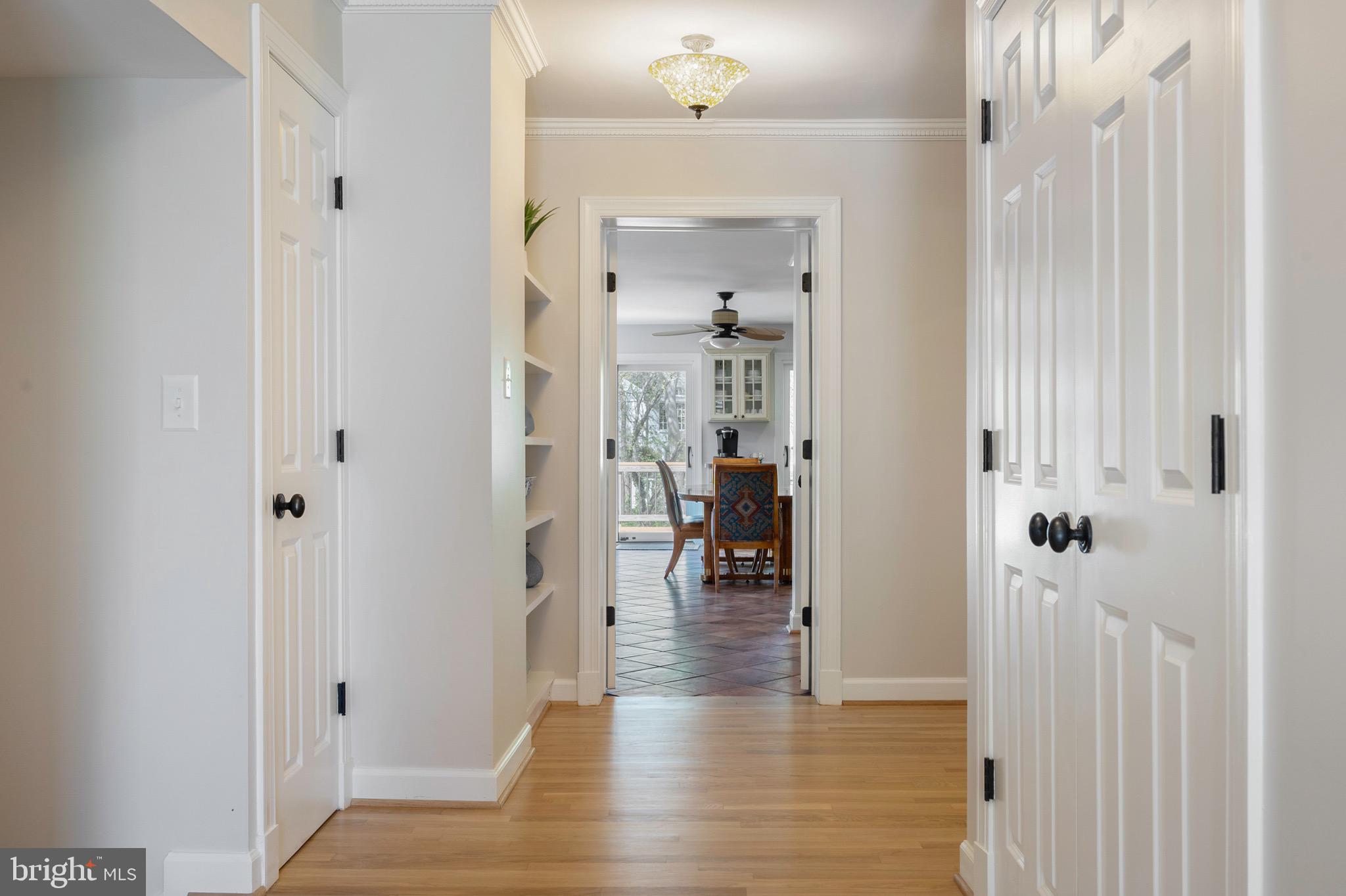902 Emerald Drive Alexandria, VA 22308 - Photo 11 of 97 a view of a hallway with dining room and wooden floor