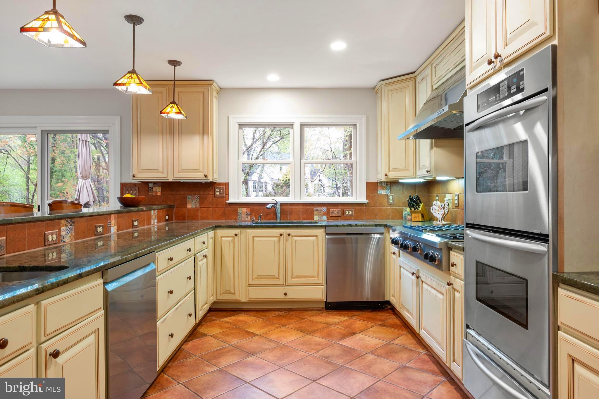 902 Emerald Drive Alexandria, VA 22308 - Photo 17 of 97 a kitchen with stainless steel appliances granite countertop a stove a sink and a refrigerator