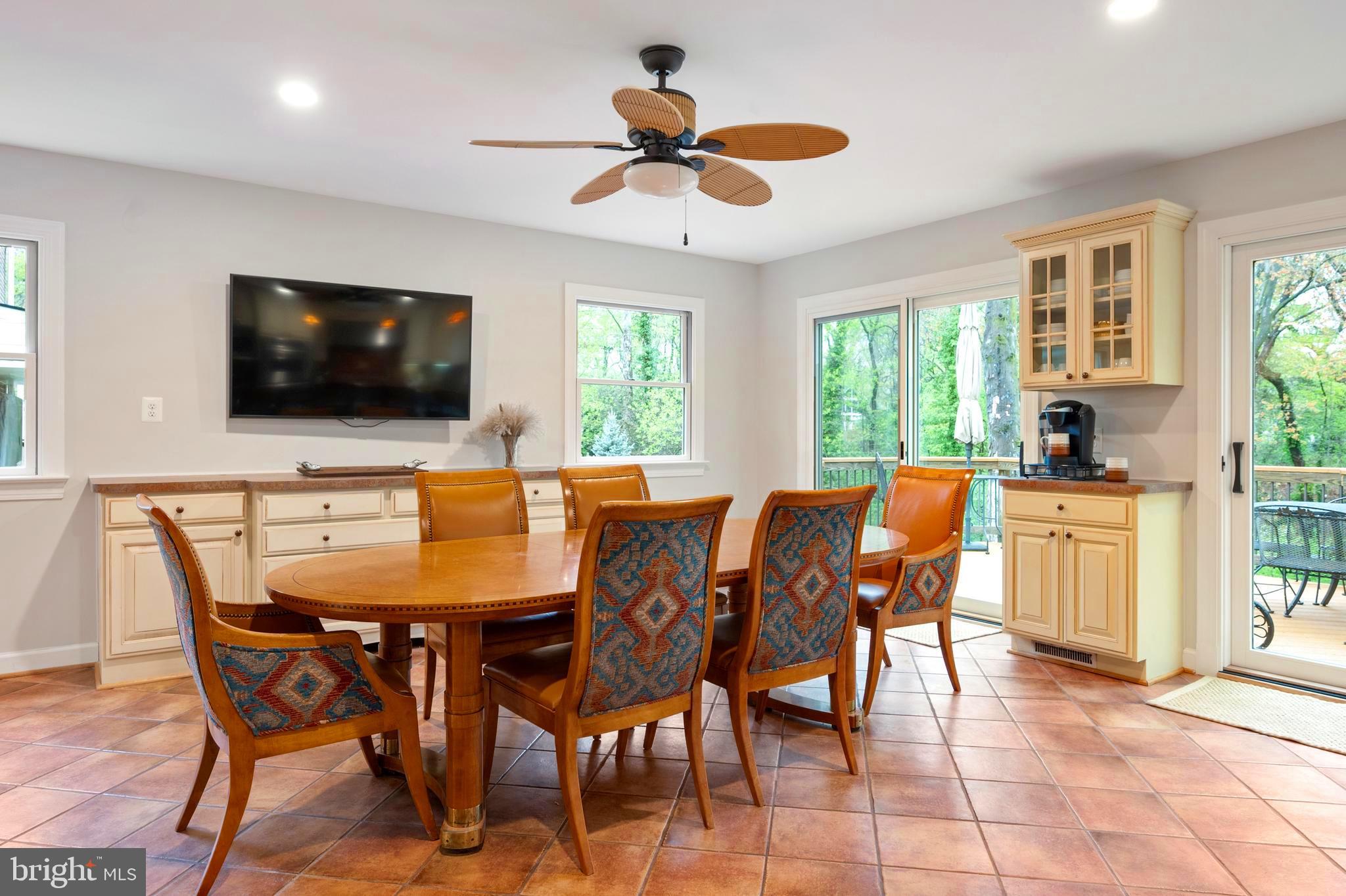 902 Emerald Drive Alexandria, VA 22308 - Photo 21 of 97 a view of a dining room with furniture and a flat screen tv
