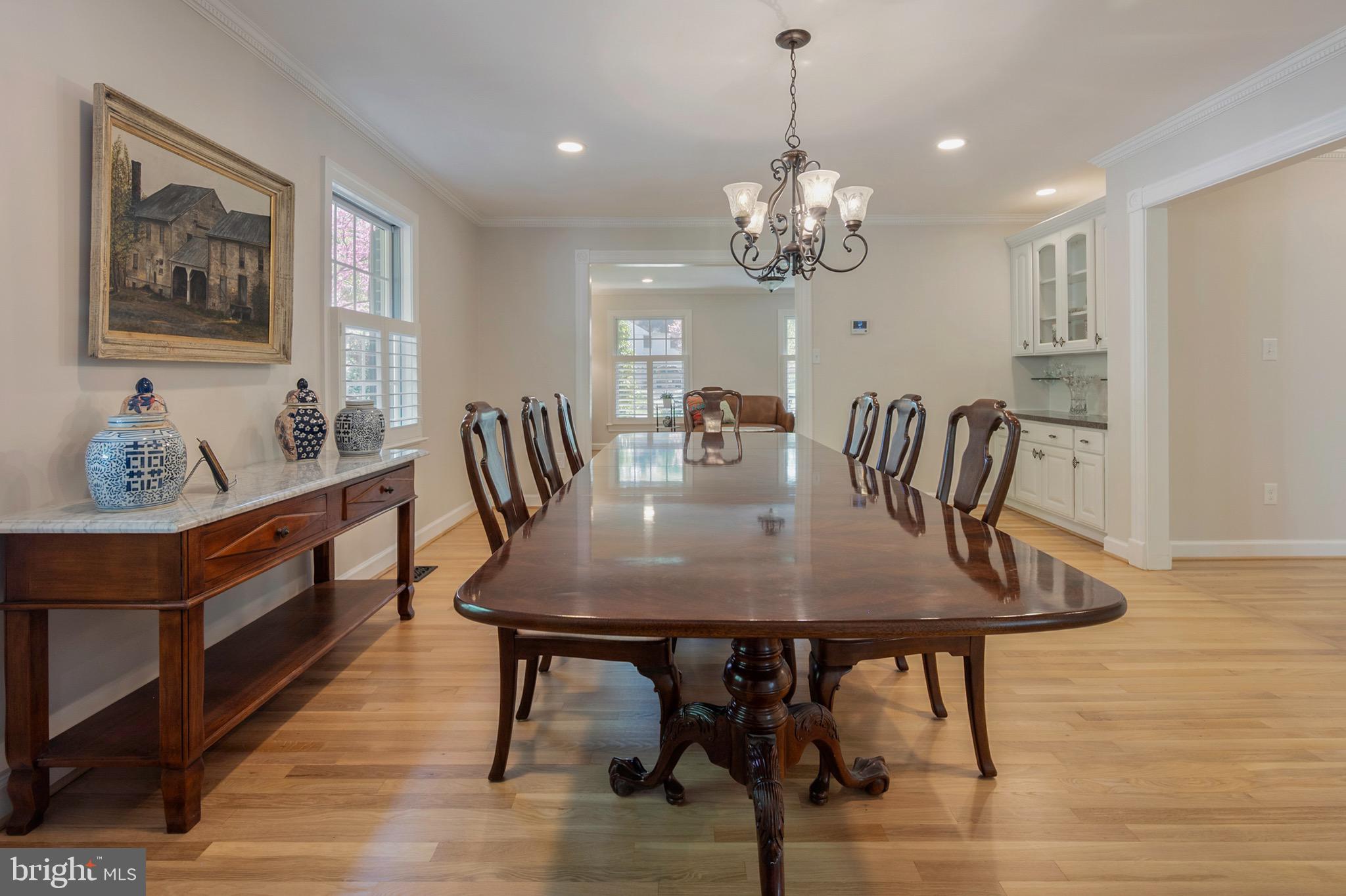 902 Emerald Drive Alexandria, VA 22308 - Photo 25 of 97 a view of a dining room with furniture a chandelier and wooden floor