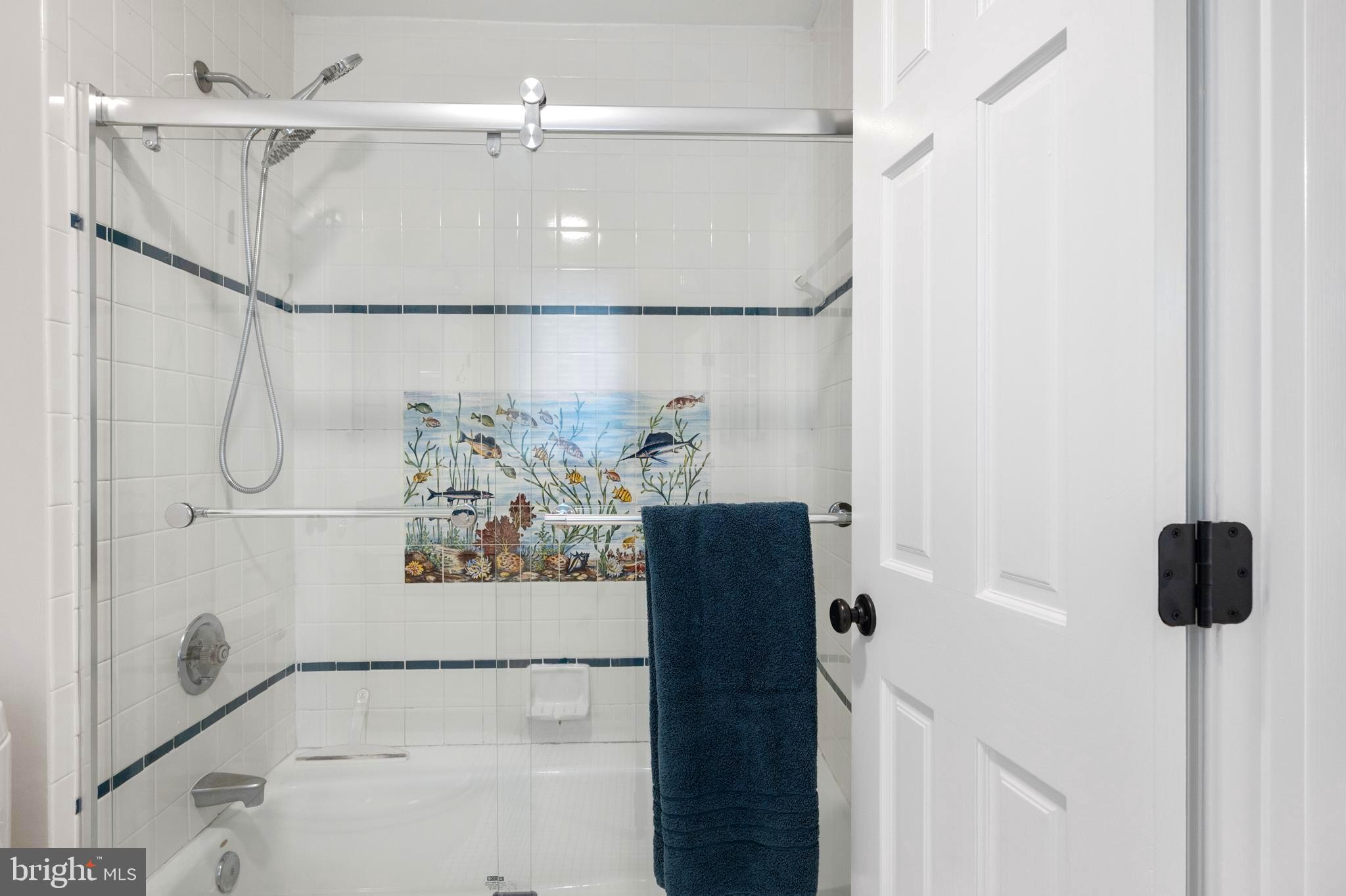 902 Emerald Drive Alexandria, VA 22308 - Photo 42 of 97 a bathroom with a bathtub and a shower