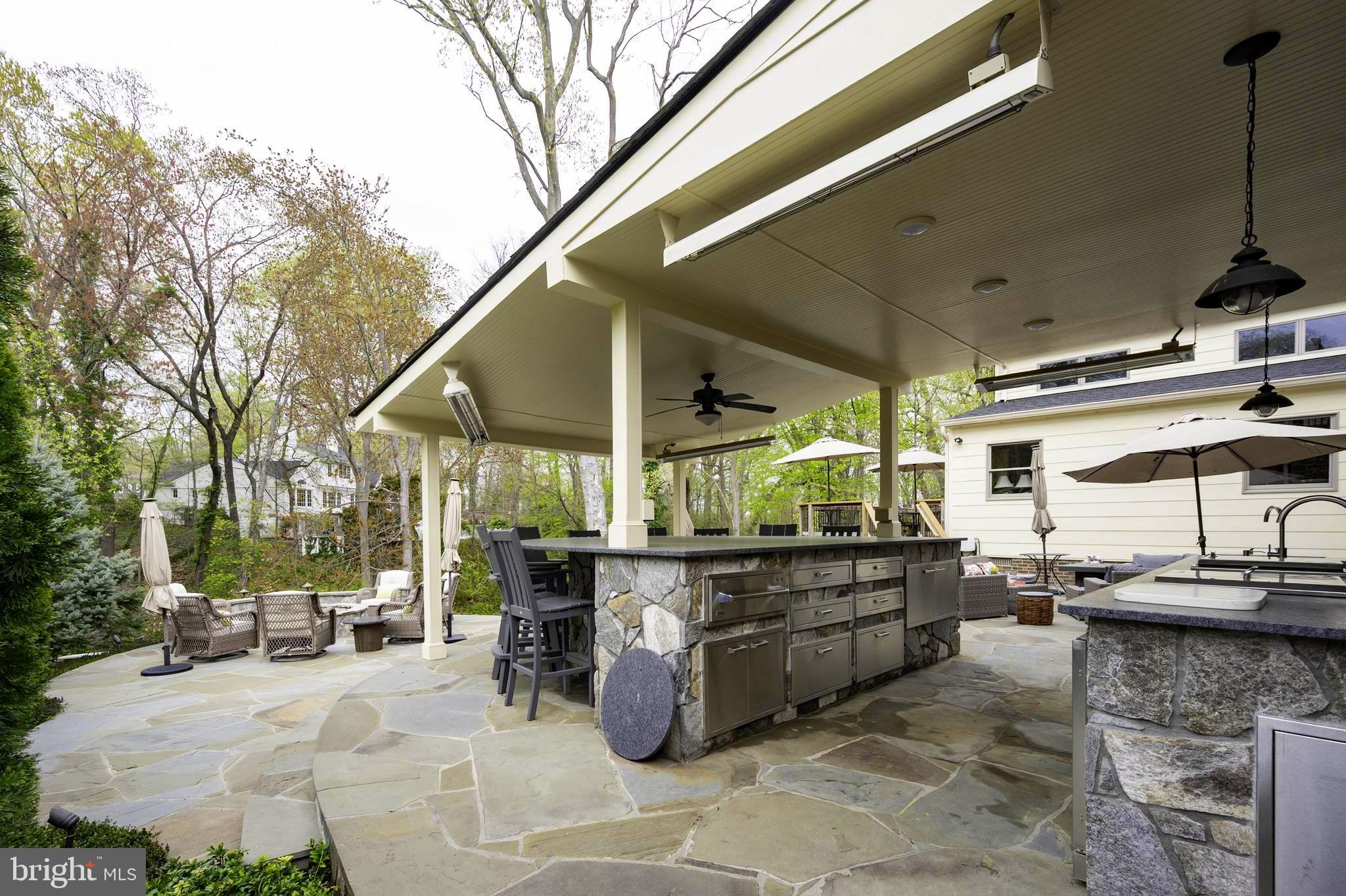 902 Emerald Drive Alexandria, VA 22308 - Photo 65 of 97 a view of a patio with table and chairs potted plants