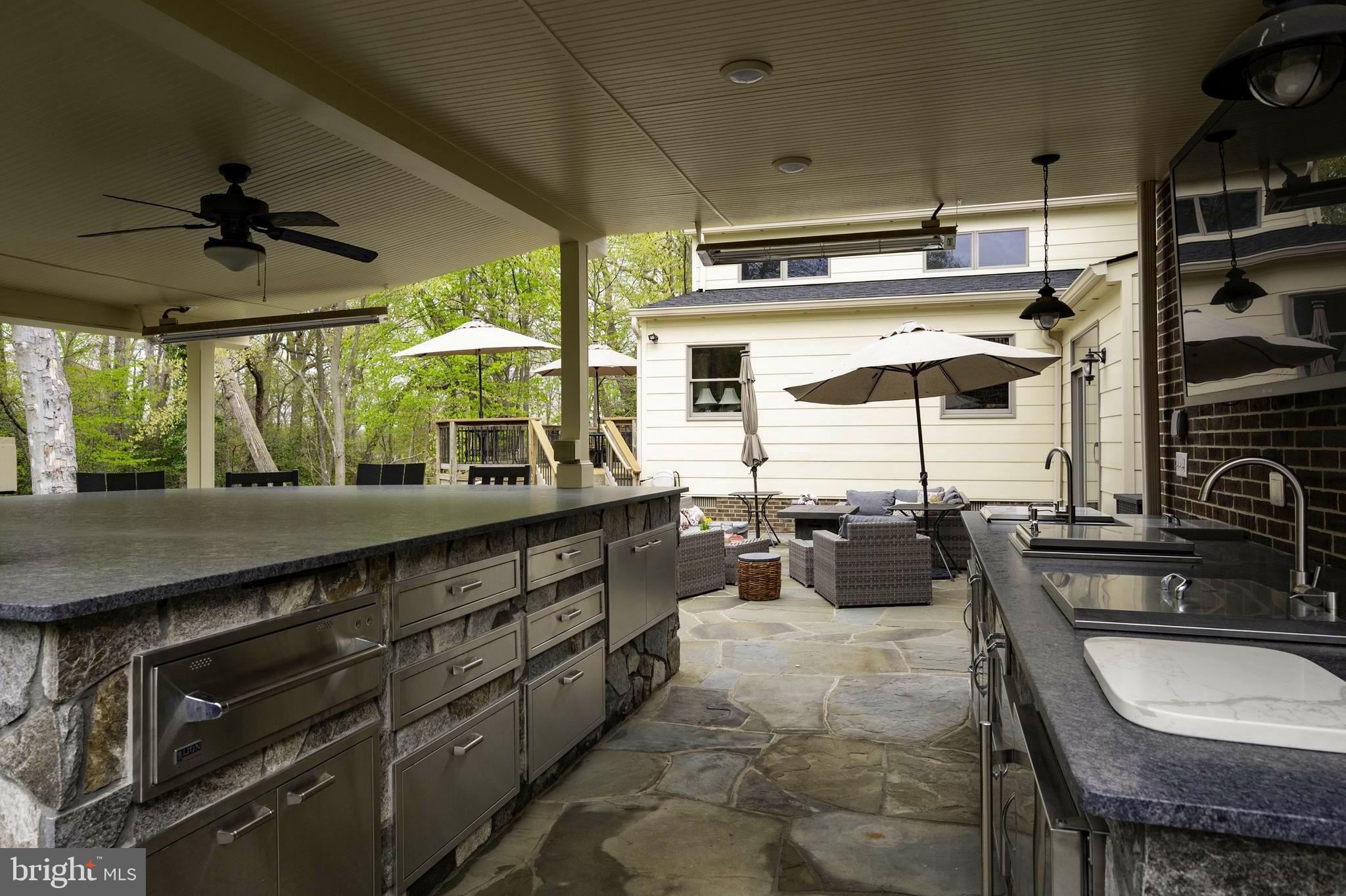 902 Emerald Drive Alexandria, VA 22308 - Photo 66 of 97 a kitchen with stainless steel appliances granite countertop a sink a stove and a wooden cabinets
