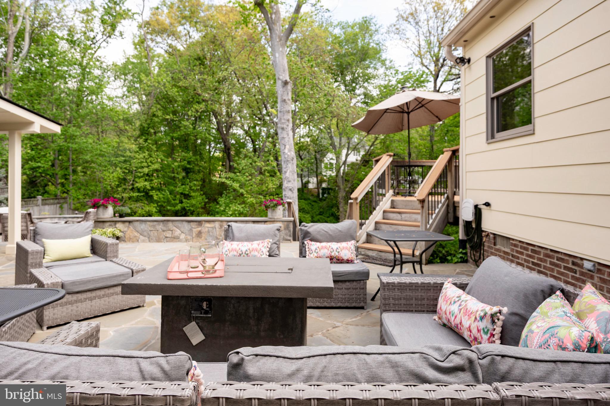 902 Emerald Drive Alexandria, VA 22308 - Photo 8 of 97 a view of a patio with couches table and chairs and potted plants