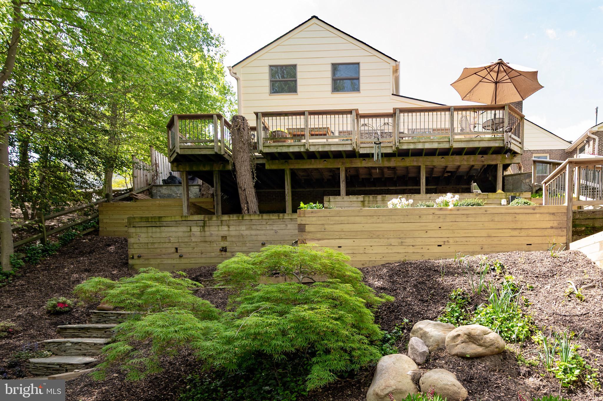 902 Emerald Drive Alexandria, VA 22308 - Photo 83 of 97 a front view of a house with a yard and potted plants