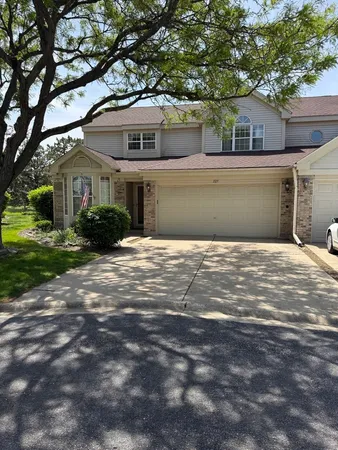 a front view of a house with a yard and garage