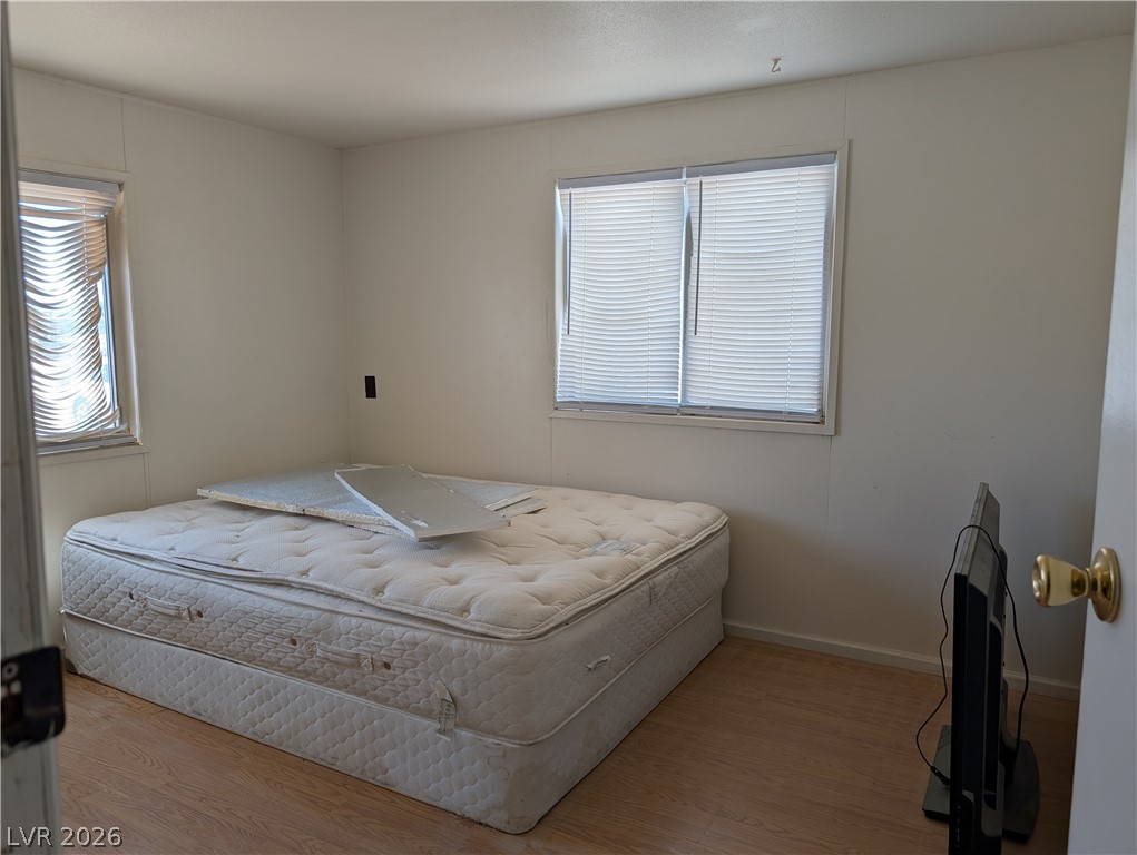 2350 Shawnee Street Sandy Valley, NV 89019 - Photo 8 of 38 Bedroom with wood finished floors and baseboards