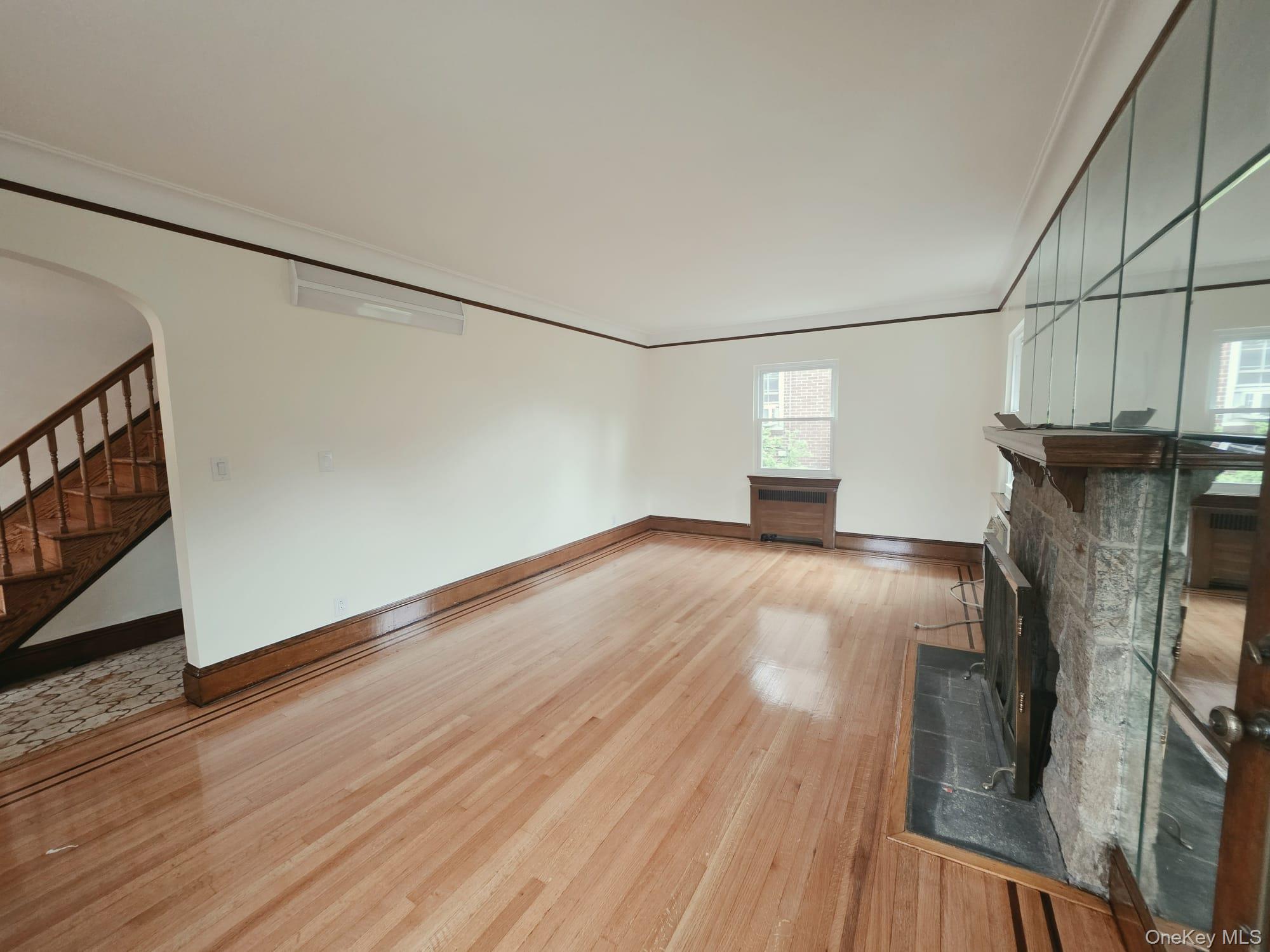 180-15 Dalny Road Queens, NY 11432 - Photo 3 of 10 a view of a livingroom with wooden floor