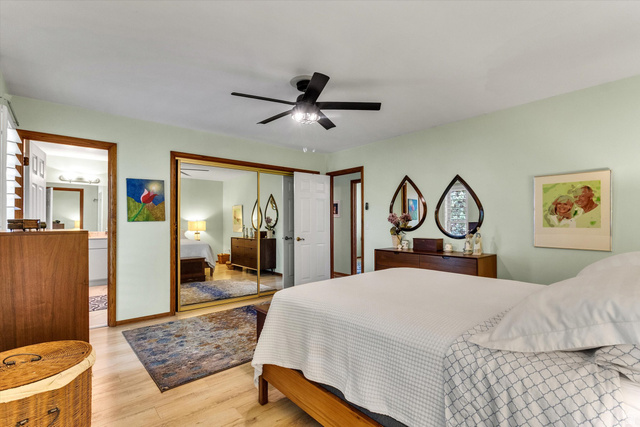 2863 Fallentine Road Sandy, UT 84093 - Photo 32 of 48 Bedroom featuring wood-finish flooring, a ceiling fan with integrated lighting, and a mirrored closet with gold-tone framing