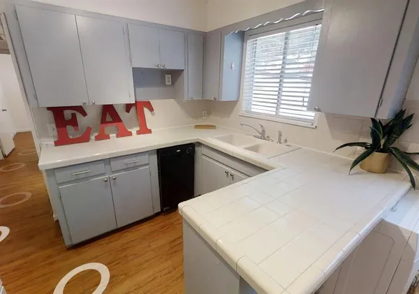 a kitchen with a sink a stove and cabinets